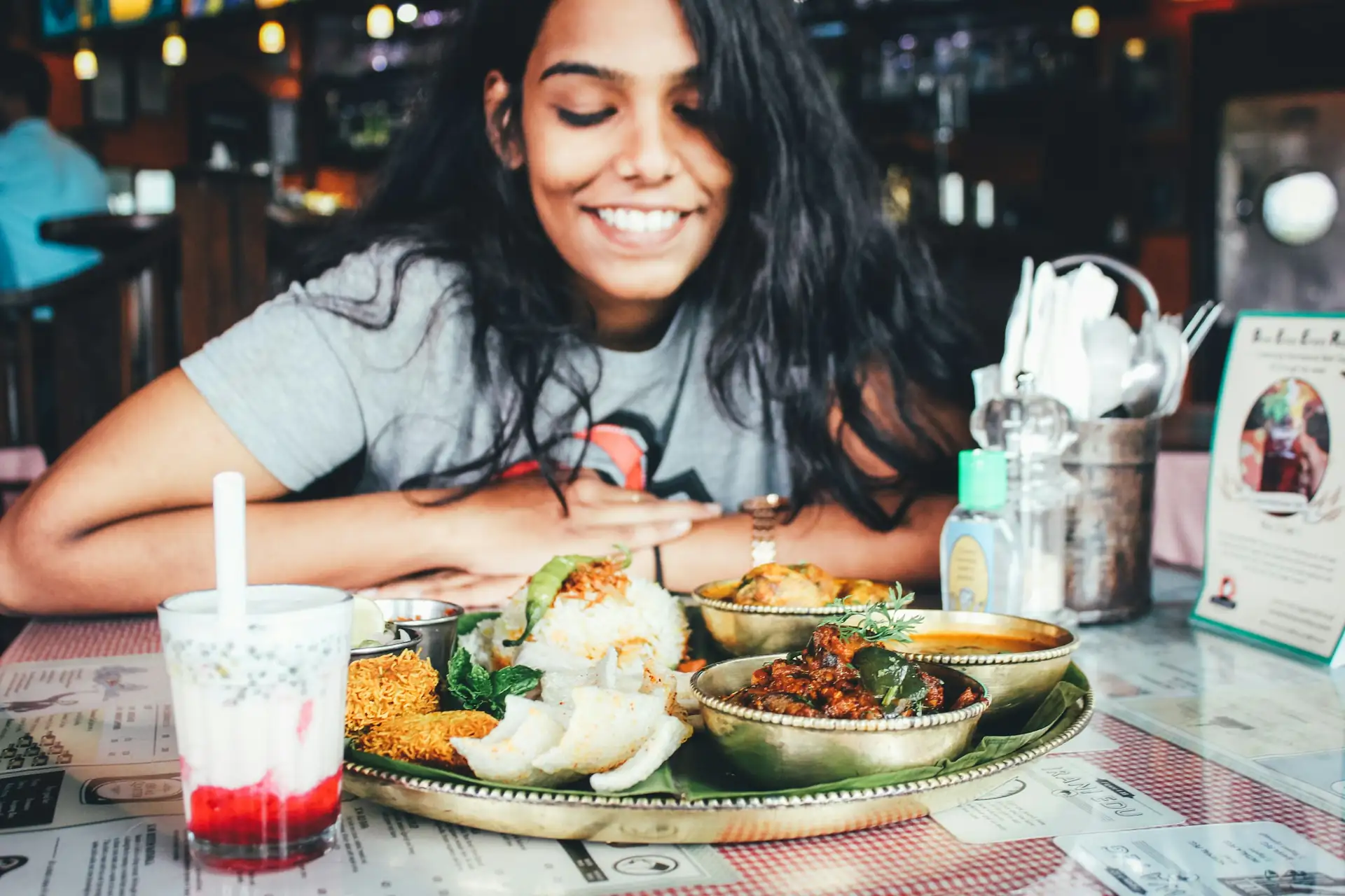 A guest smiling at a table laid with several dishes
